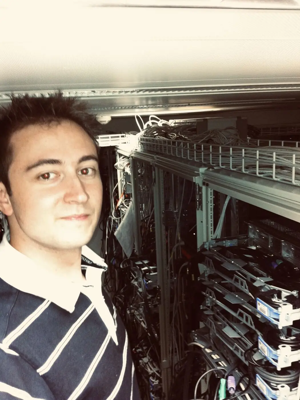 Michael Kälin 2011 im Rechenzentrum vor Grossrechner-Racks mit AS/400-Systemen